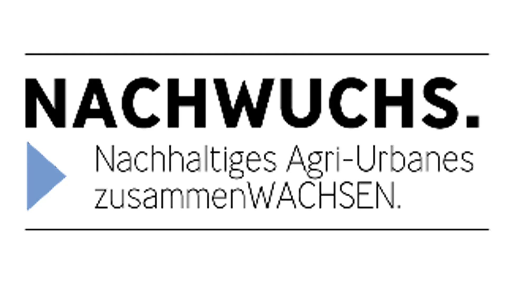 Eine Wissenschaftlerin und ein Wissenschaftler arbeiten hinter einer Glasfassade und mischen Chemikalien mit Großgeräten.